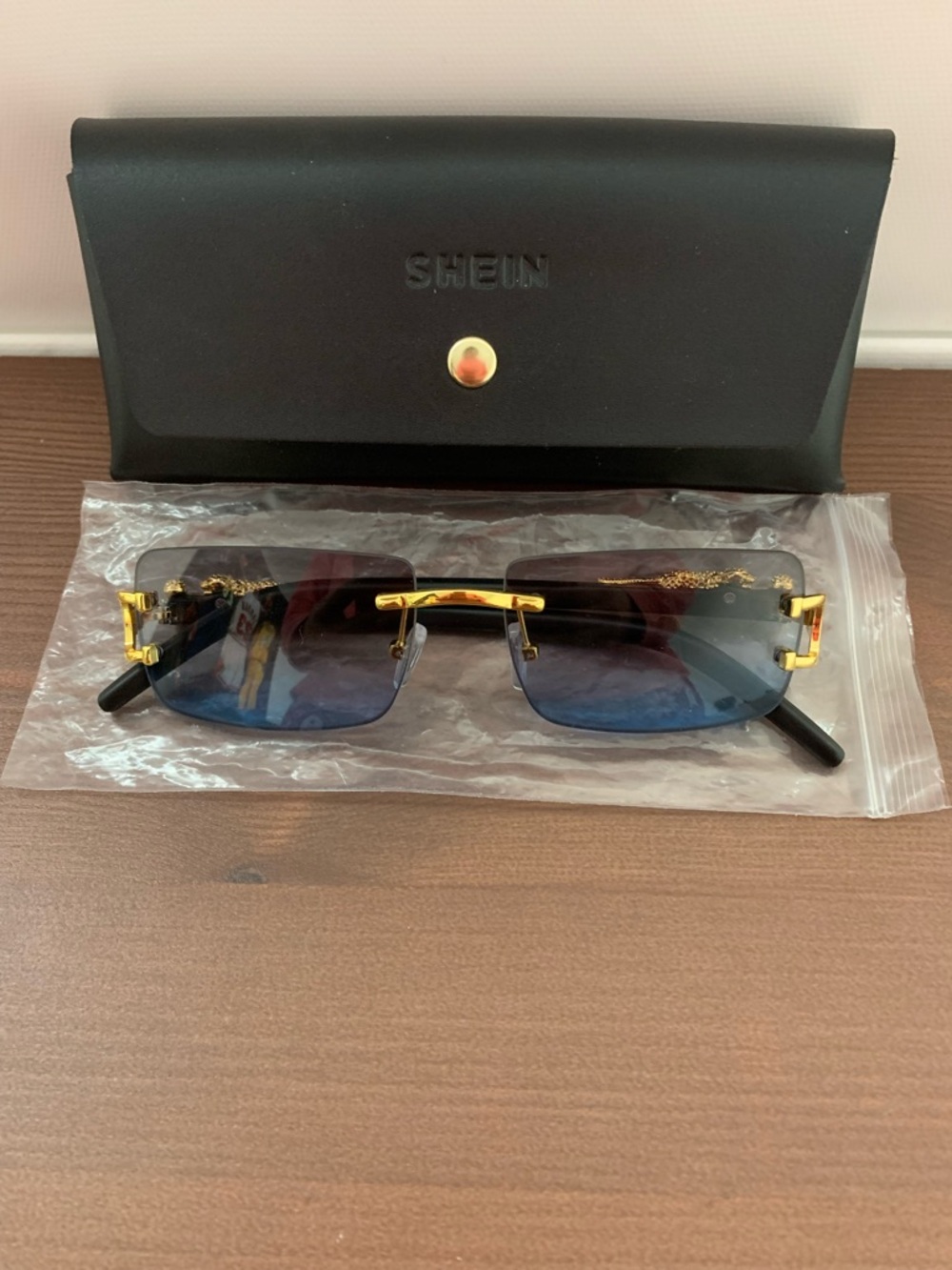 Gold-Accent Rimless Sunglasses with Blue Gradient Lenses